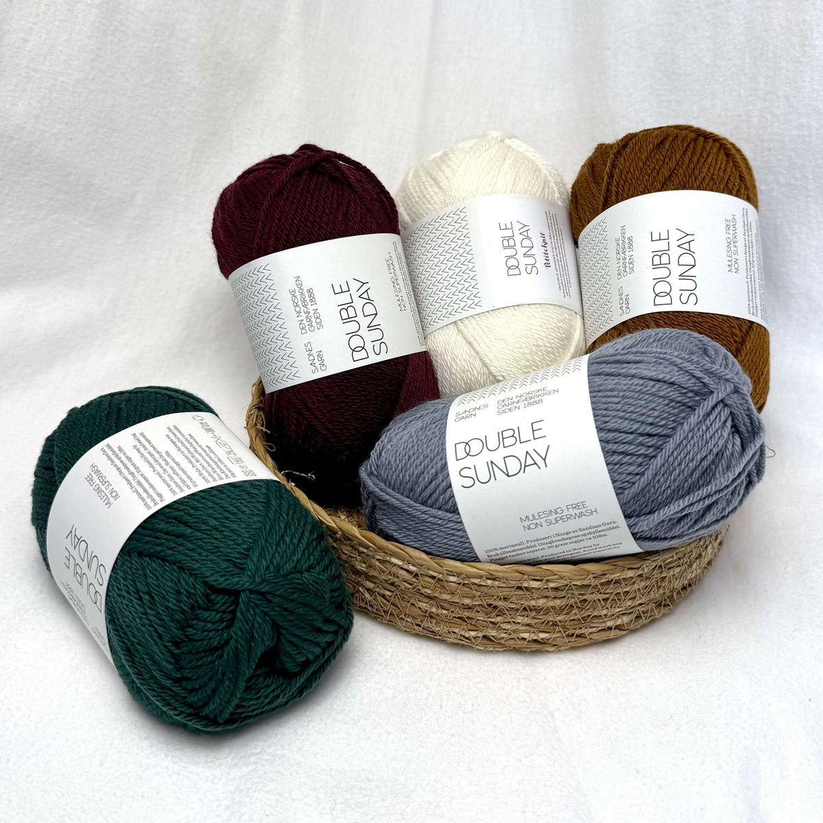 A pile of different colours of Sandnes Garn Double Sunday yarn