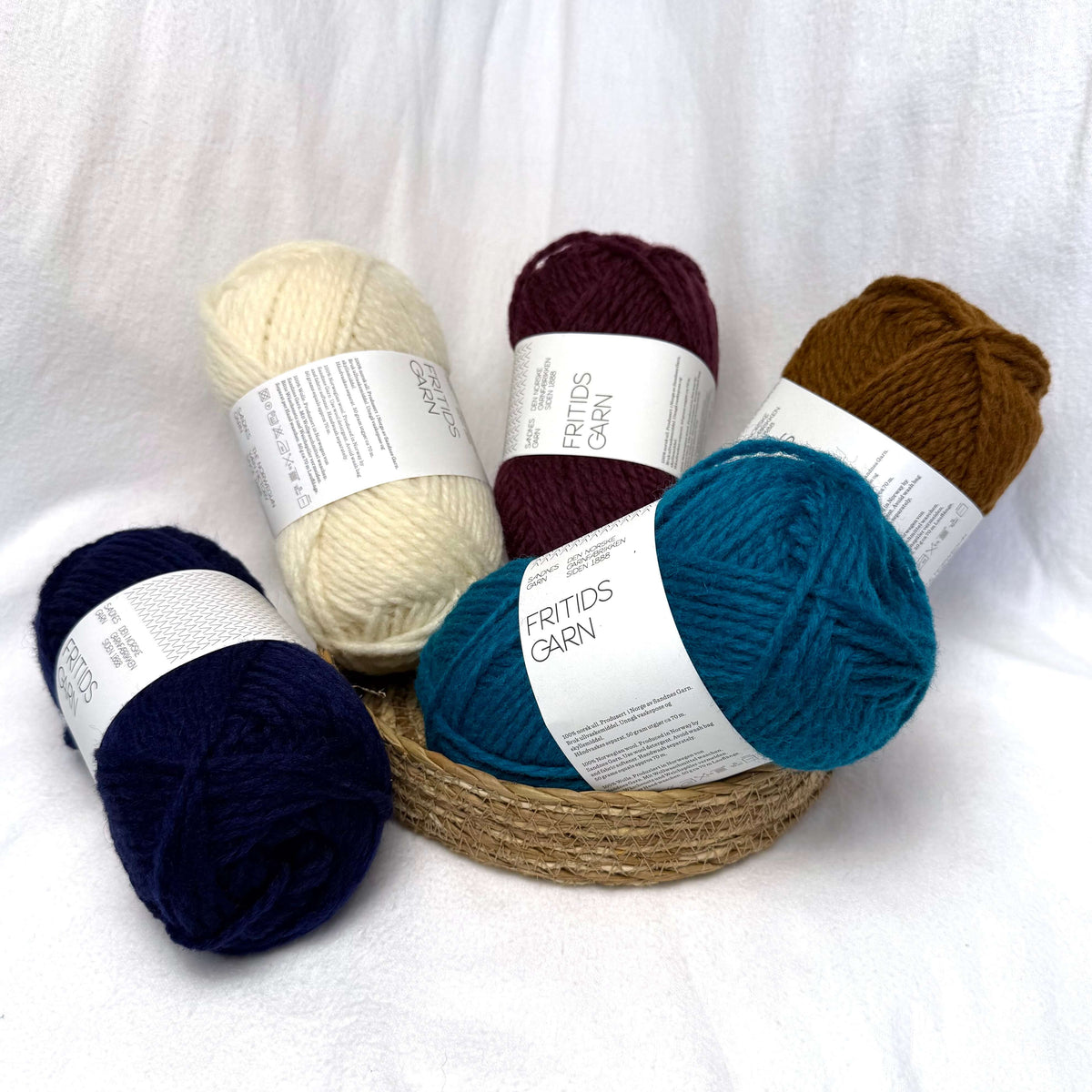 A pile of different colours of Sandnes Garn Fritidsgarn yarn