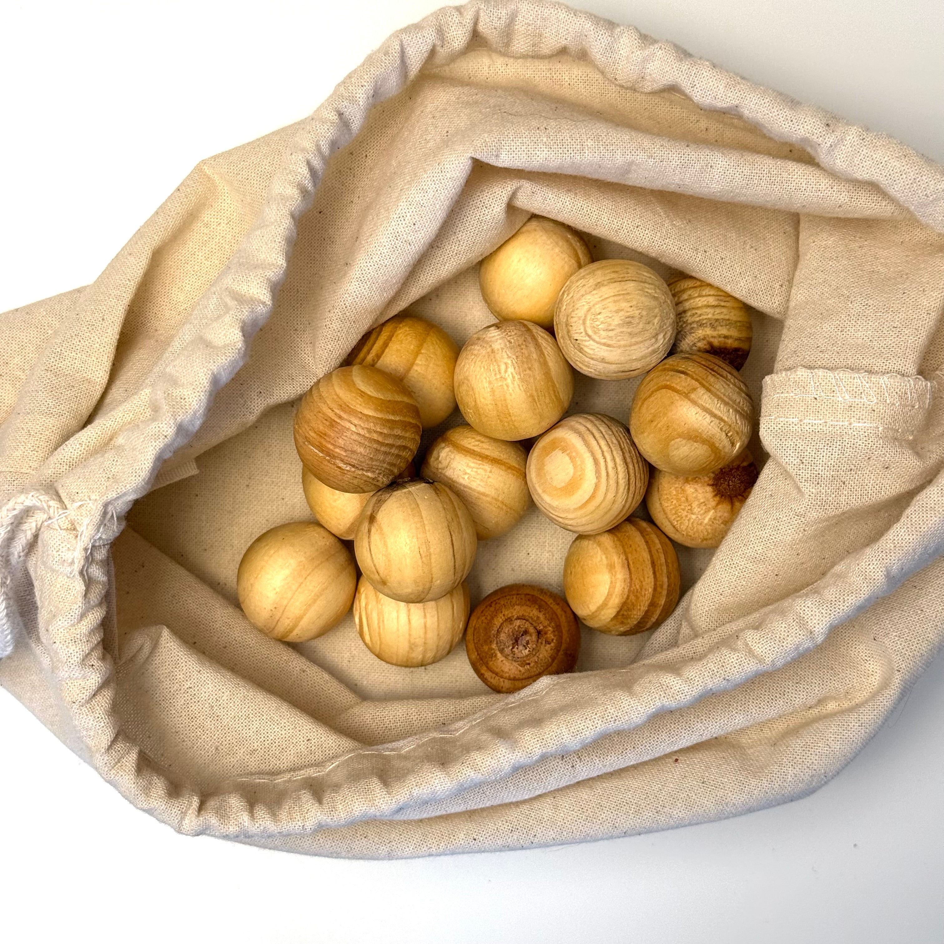 Sixteen cedar moth balls in a cotton drawstring bag
